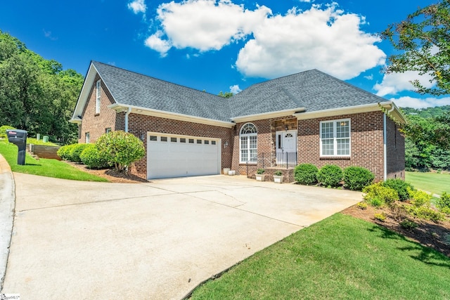 view of front of property featuring a garage and a front lawn