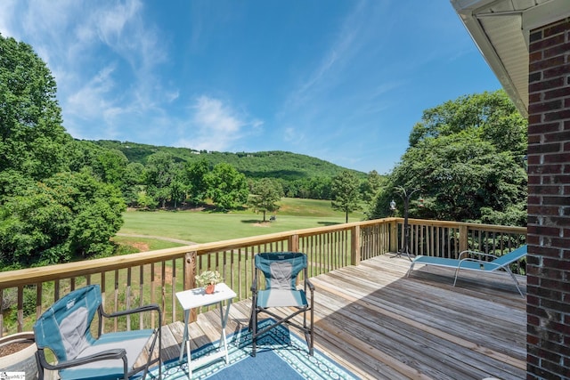 wooden deck featuring a yard