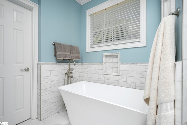 bathroom with a tub to relax in, tile walls, and ornamental molding