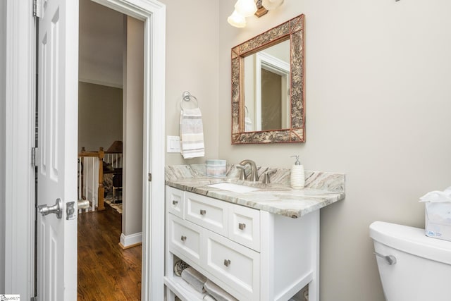 bathroom featuring vanity, toilet, and wood-type flooring