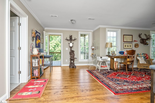 sitting room featuring hardwood / wood-style floors and crown molding