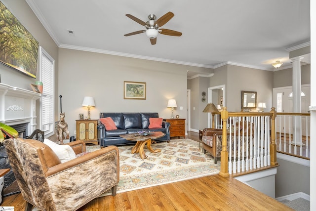 living room with ornamental molding, a wealth of natural light, ceiling fan, and wood-type flooring