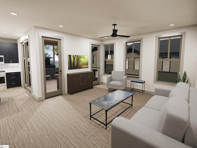 living room with ceiling fan and light hardwood / wood-style flooring