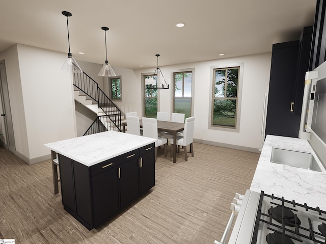 kitchen with pendant lighting, a breakfast bar area, light hardwood / wood-style floors, and a kitchen island