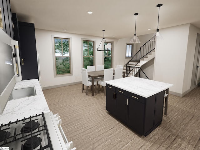 kitchen featuring light wood-type flooring, pendant lighting, a center island, and a breakfast bar area