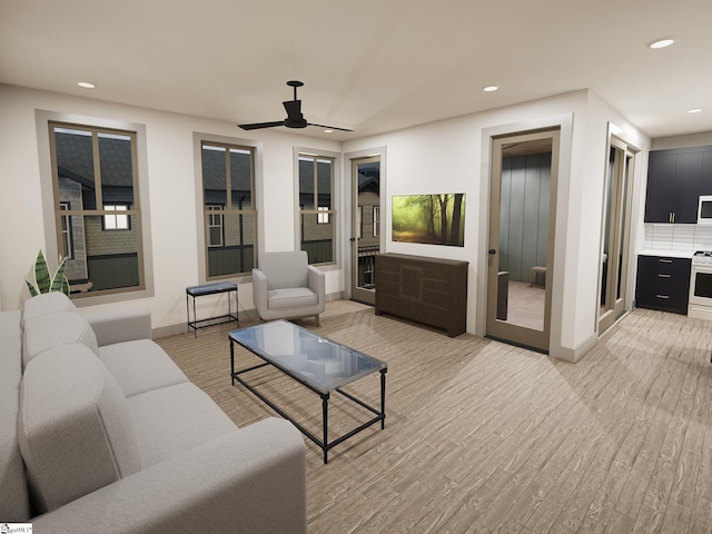 living area with a ceiling fan, recessed lighting, light wood-style flooring, and baseboards