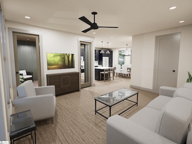 living area featuring light wood finished floors, ceiling fan, and recessed lighting