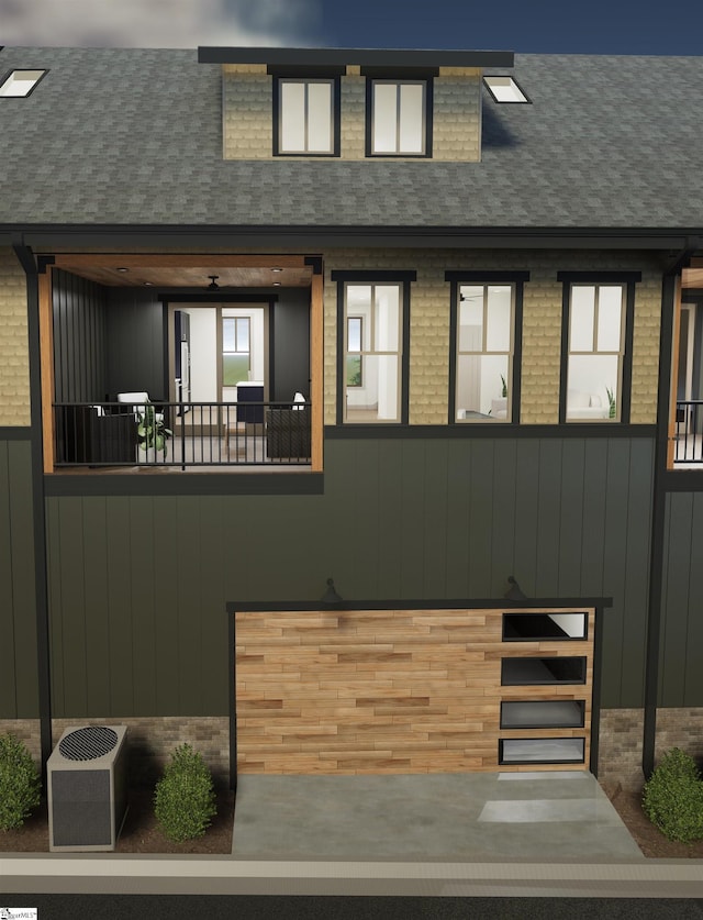 exterior space with brick siding, roof with shingles, and an attached garage