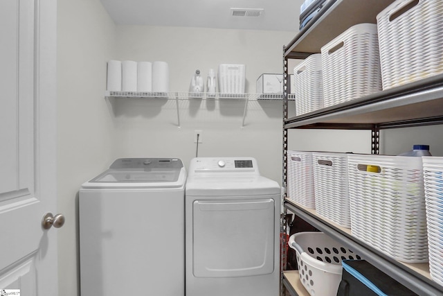 laundry area featuring washing machine and clothes dryer