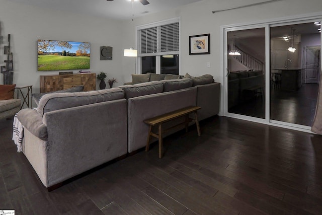 living room with dark hardwood / wood-style floors and ceiling fan