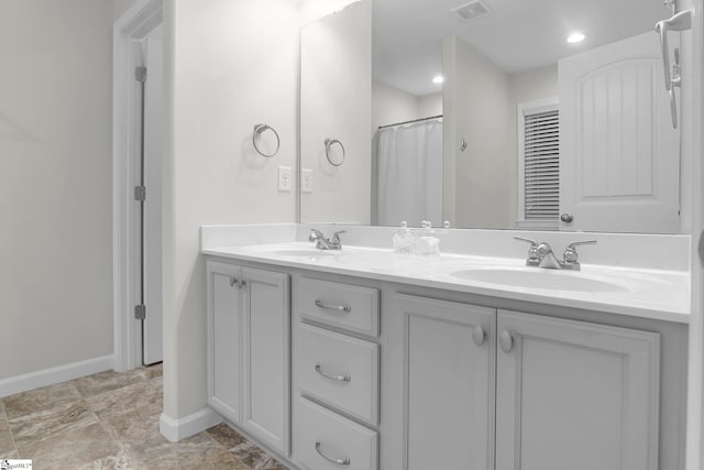 bathroom featuring vanity and curtained shower