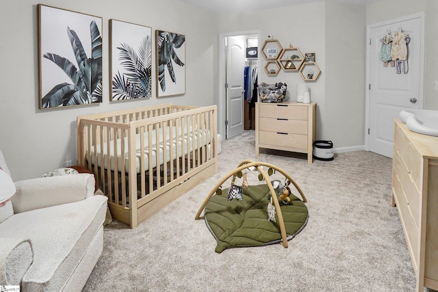 bedroom featuring light colored carpet, a nursery area, and sink