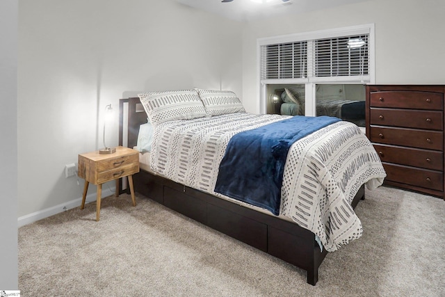 bedroom with ceiling fan and light carpet