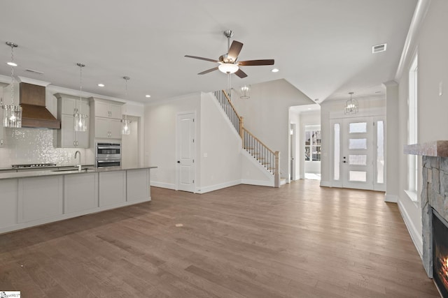 108 Cambie Pl, Greenville, SC 29607 - kitchen with custom range hood, double oven, recessed lighting, wood finished floors, and a fireplace