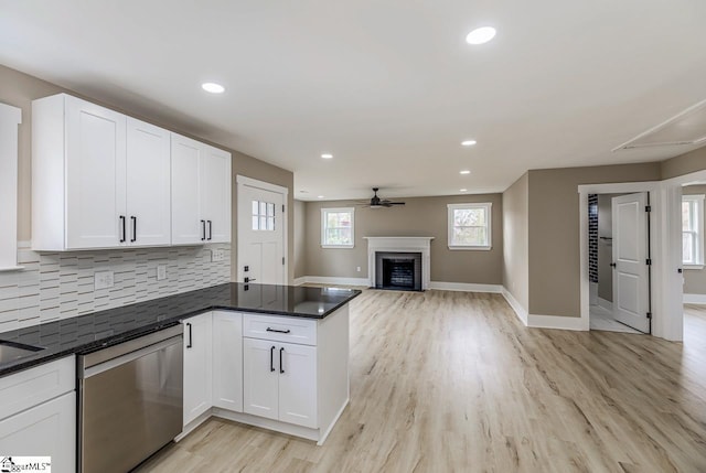 kitchen with dishwasher, kitchen peninsula, ceiling fan, light wood-type flooring, and white cabinetry