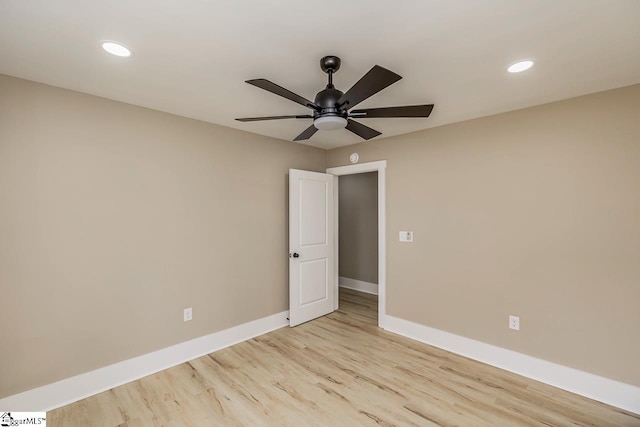 spare room featuring ceiling fan and light hardwood / wood-style flooring