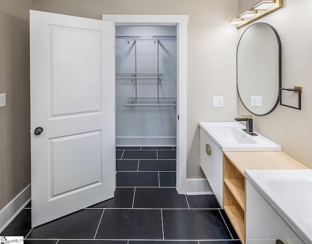 bathroom with tile patterned floors and vanity