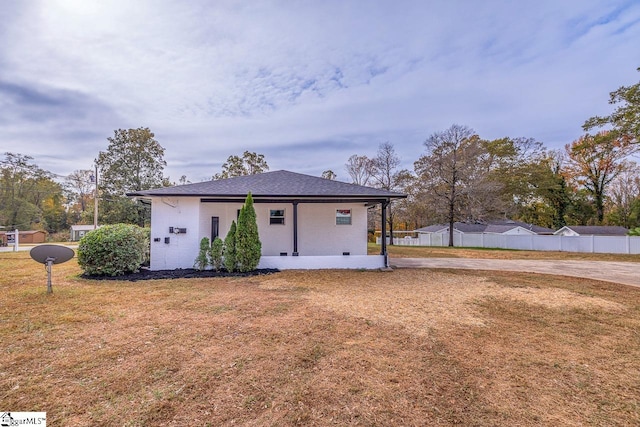 rear view of house with a yard