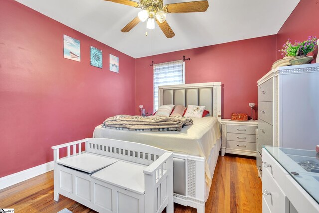 bedroom with light hardwood / wood-style floors and ceiling fan