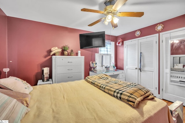 bedroom featuring ceiling fan and multiple closets