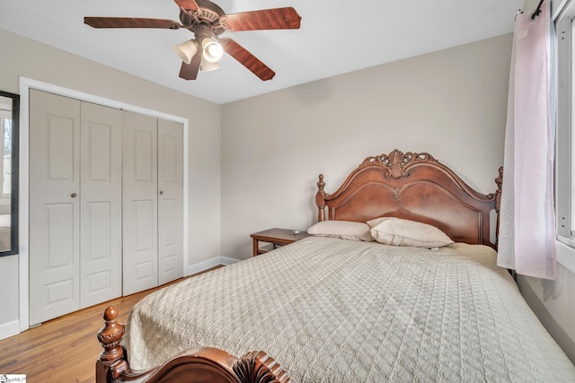 bedroom with a closet, hardwood / wood-style flooring, and ceiling fan