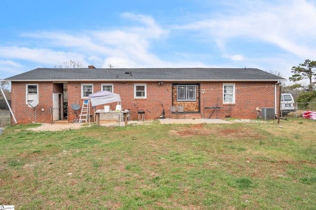 back of property featuring a yard, central AC unit, and a patio area