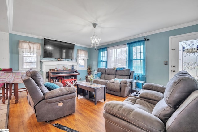 living room featuring a healthy amount of sunlight, light hardwood / wood-style floors, and an inviting chandelier