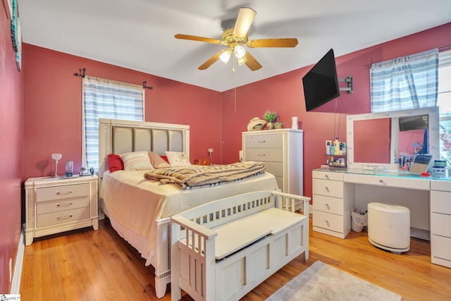 bedroom with light wood-type flooring and ceiling fan