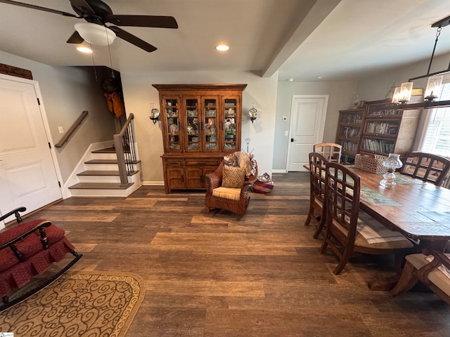 dining space with dark hardwood / wood-style floors and ceiling fan with notable chandelier