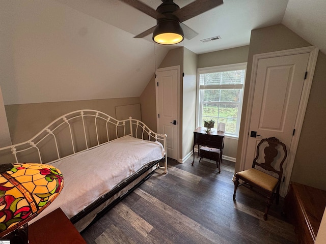 bedroom featuring ceiling fan, dark hardwood / wood-style flooring, and lofted ceiling