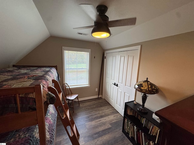 bedroom with a closet, ceiling fan, dark hardwood / wood-style flooring, and lofted ceiling