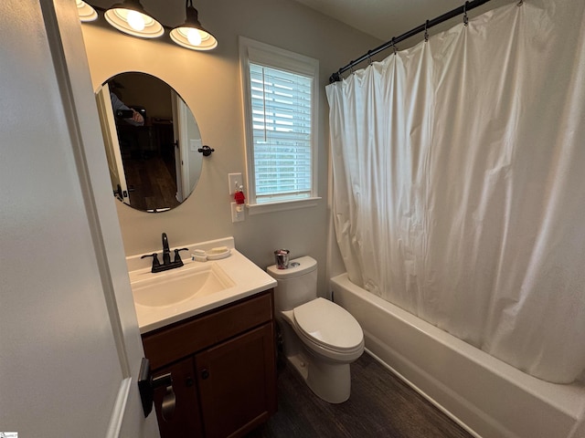 full bathroom featuring hardwood / wood-style floors, vanity, toilet, and shower / bath combo