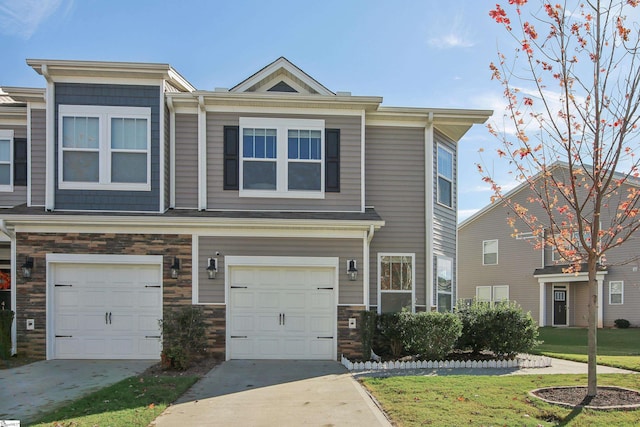 view of property with a front yard and a garage