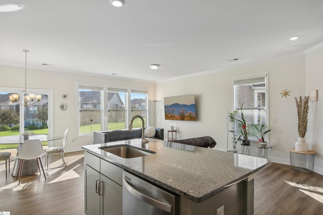 kitchen with stainless steel dishwasher, sink, a center island with sink, dark stone countertops, and dark hardwood / wood-style floors