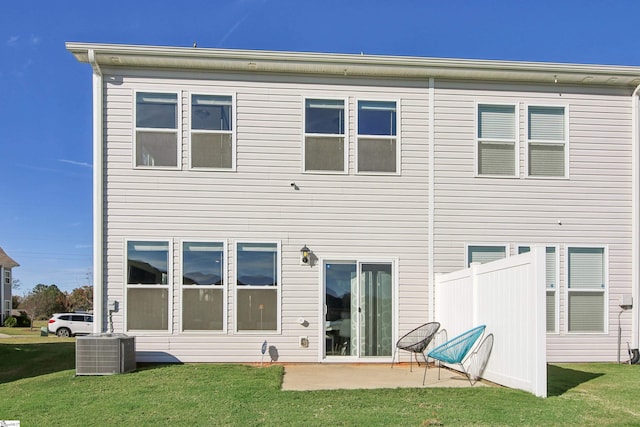 rear view of house with a patio area, a yard, and cooling unit