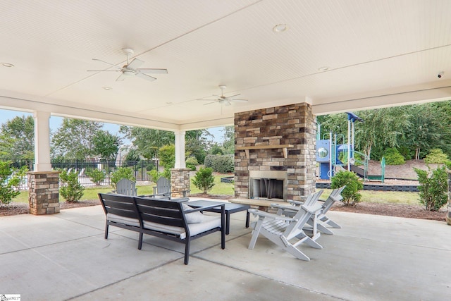 view of patio / terrace with an outdoor stone fireplace and ceiling fan