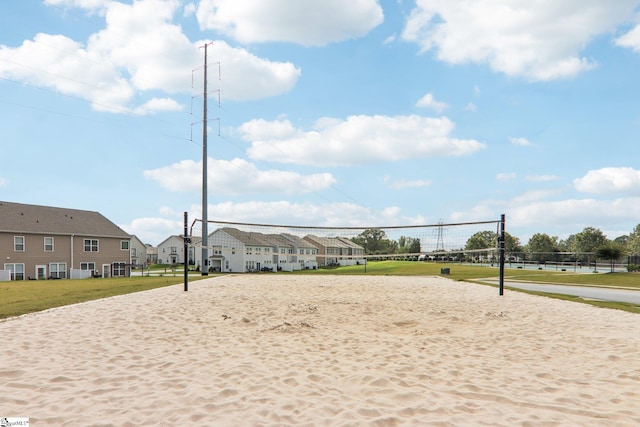 view of property's community with volleyball court and a lawn