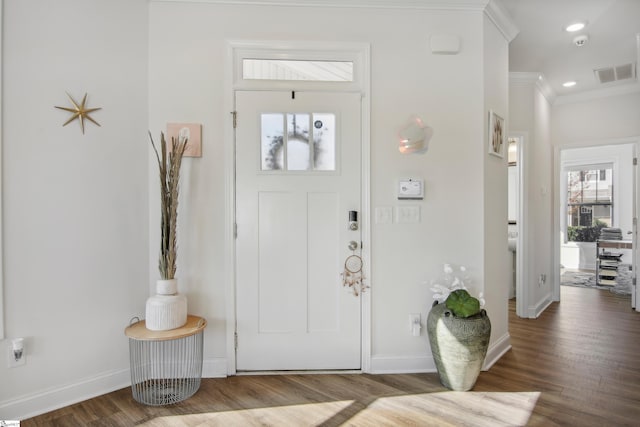 foyer featuring hardwood / wood-style flooring and crown molding