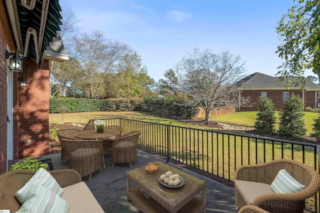 deck with outdoor lounge area, a patio, and a lawn