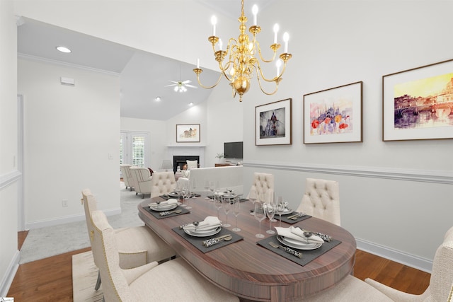 dining room featuring hardwood / wood-style floors, ceiling fan, lofted ceiling, and crown molding