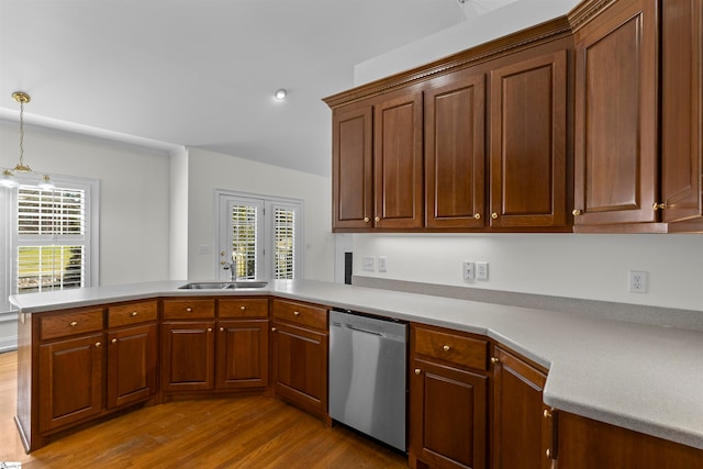 kitchen featuring sink, dishwasher, hanging light fixtures, kitchen peninsula, and light hardwood / wood-style floors