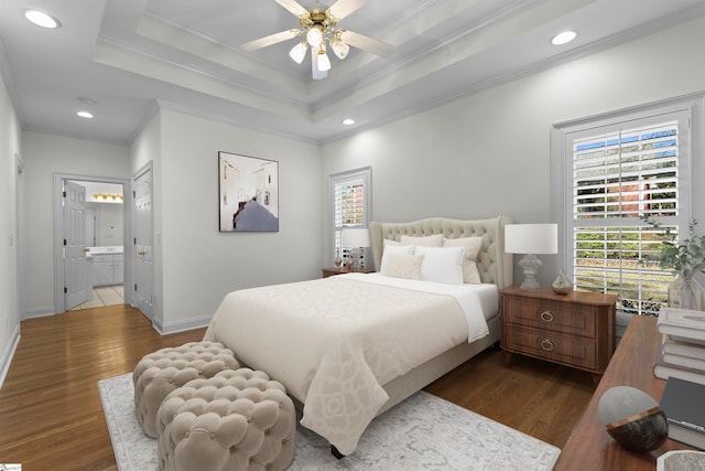 bedroom featuring ensuite bath, a raised ceiling, ceiling fan, crown molding, and dark hardwood / wood-style floors