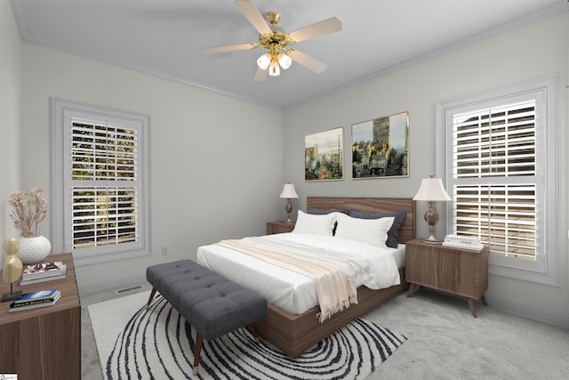 carpeted bedroom with ceiling fan and ornamental molding