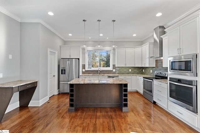 kitchen featuring white cabinets, appliances with stainless steel finishes, and a center island