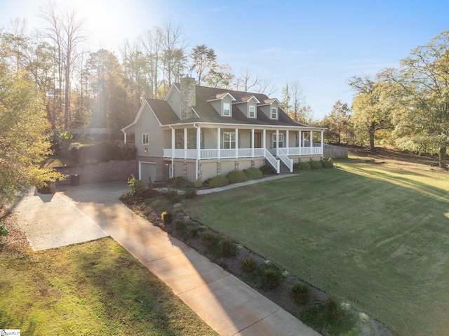 view of front of property featuring covered porch, a garage, and a front yard