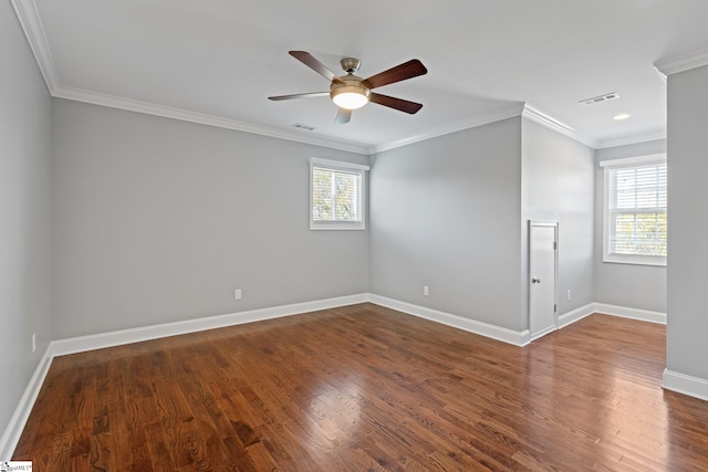 spare room with crown molding, dark wood-type flooring, ceiling fan, and a healthy amount of sunlight