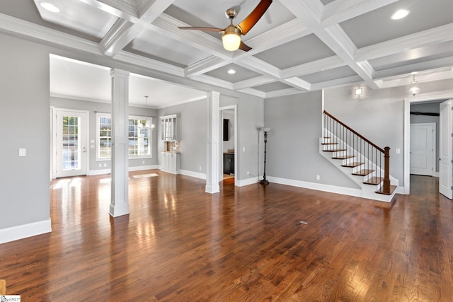 unfurnished living room featuring coffered ceiling, beamed ceiling, dark hardwood / wood-style floors, crown molding, and ceiling fan with notable chandelier