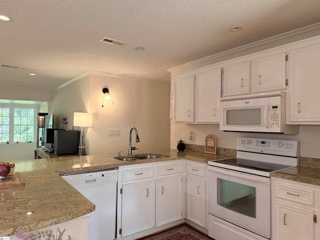 kitchen with white cabinetry, white appliances, and sink