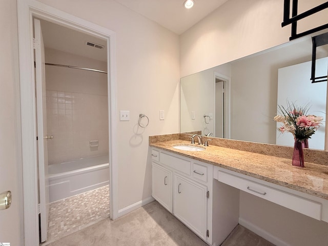 bathroom featuring vanity and tiled shower / bath combo