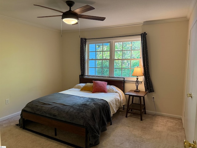 carpeted bedroom with ceiling fan and ornamental molding